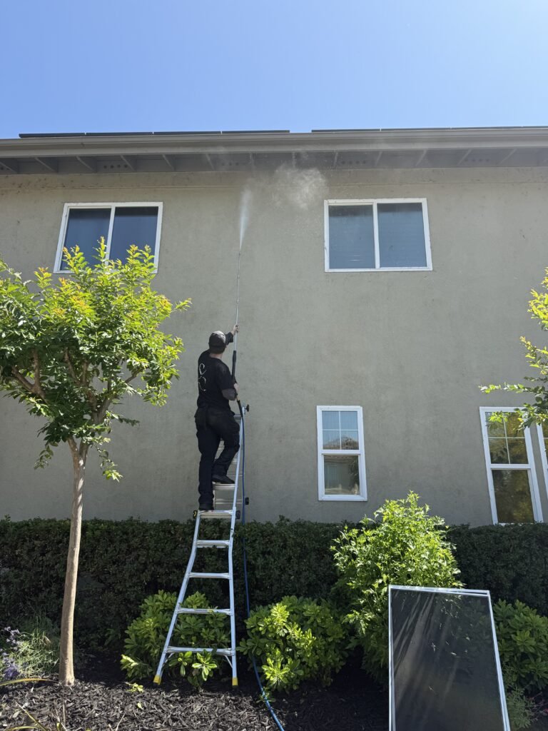 Cleaning upper windows on a home exterior
